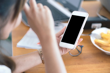 Close up of Asian women's hands holding cell telephone with blank copy space scree for your advertising text message or promotional content, Concept : working, meeting, study, education in coffee shop
