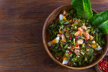 Top view of Wing Bean Shrimp Salad (Yum Tua Poo) in the wooden dish on the wooden table,HealthyThai...