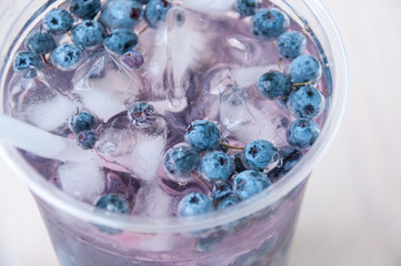 Blueberry cocktail with ice cubes closeup