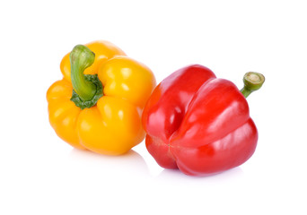 whole fresh yellow and red bell pepper with stem on white background