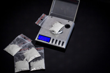 scales and many cocaine on black table - 169793613