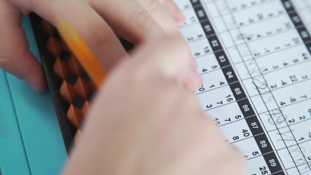 Systems of children's development: mental arithmetic. The boy is studying the accounts with the help of Abakus (Soroban) - a special tool for practicing the method of mental arithmetic.