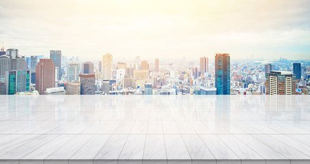 Business concept - Empty marble floor top with panoramic modern cityscape building bird eye aerial view under sunrise and morning blue bright sky of Osaka, Japan for display or montage product