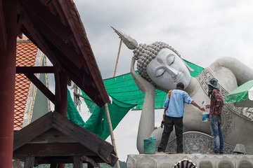 Men who renovate buddhist sculpture in temple