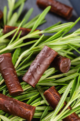 Homemade chocolate candy sticks with rosemary