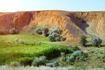 Beautiful view of the slope with the river and the road. Dreamy look