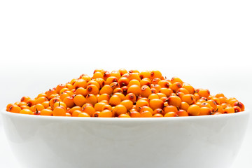 A hill of ripe sea-buckthorn berries in a cup on a white background. Isolated.