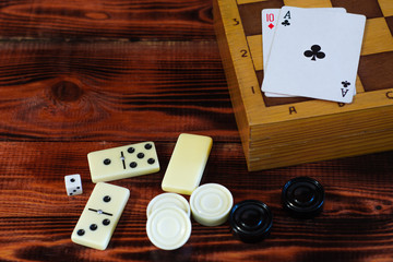 Various board games chess board, playing cards, dominoes. Hobby. Metaphor for games and gambling.
