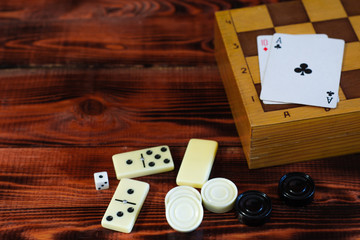 Various board games chess board, playing cards, dominoes. Hobby. Metaphor for games and gambling.