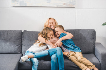 grandmother embracing her grandchildren