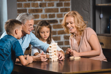 family playing blocks wood game