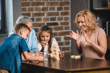 family playing blocks wood game