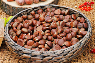 Chestnuts in a wicker basket on the burlap background