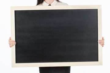 Girl (student, businesswoman) in casual clothes holding a black chalk board with empty blank space for your text. on a white background