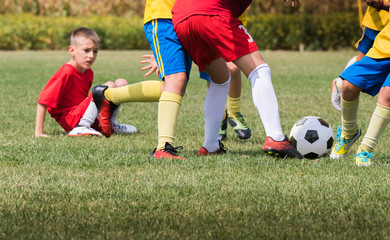 Obraz premium Kids soccer football - children players match on soccer field