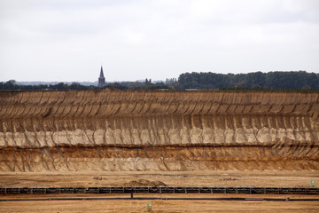 Germany, North Rhine Westphalia, -june 2017:  ground excavator in action moving mullock and soil at open pit coal mine; Germany,for winning brown coal