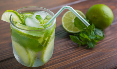 cocktail with lime and mint on a wooden table