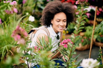 Mixed race tourist looking at flowers at the shop 