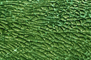 Green toned broken glass surface.