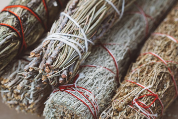Close-up of the bandaged branches of dried herbs: sage, wormwood, pine and juniper