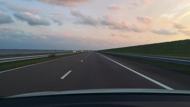 View from a car on the highway ahead during dusk
