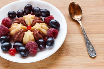 Biscuit with fresh berries on white plate. Selective focus