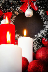 Christmas candles, Christmas decorations balls and chics in a basket on a dark background with copy space