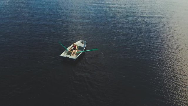 Boy Rowing Boat On Lake