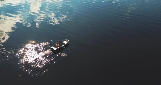 Tourist Rowing A Boat