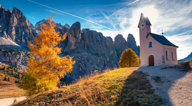Small church on the top of Gardena pass with Piz Boe mountain on background.