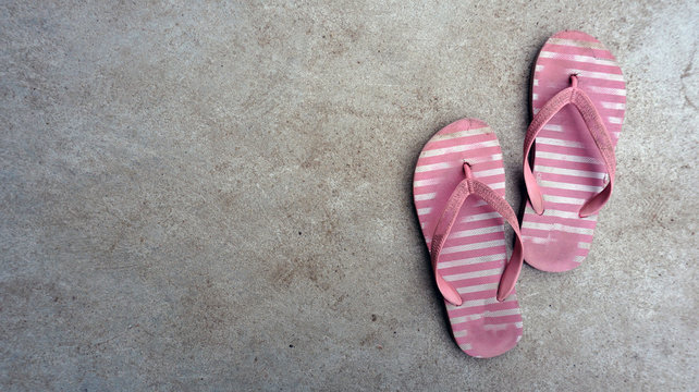 Pink sandal  shoes on cement floor.