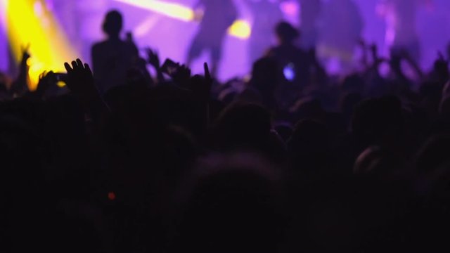 Slow motion concert crowd dancing at life music concert