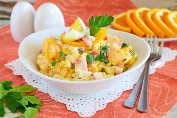 Salad made of orange, crab meat, eggs, corn served with yogurt in a white bowl on a cloth background. Simple food. Healthy eating concept
