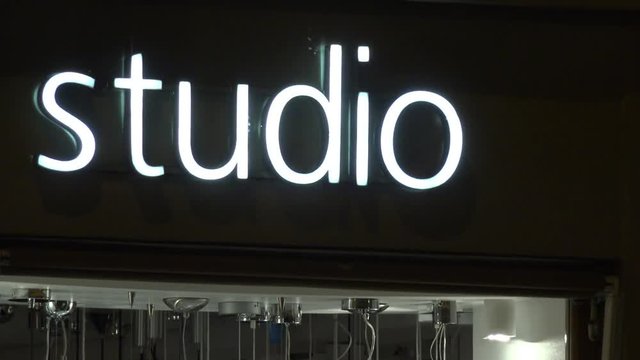 Closeup on a neon sign "studio" at night