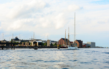 Naklejka premium Copenhagen cityscape, Denmark. Old architecture on a canal bank, panoramic view of European city