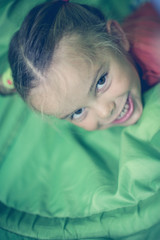 Little girl in playground. Caucasian girl looking at camera.