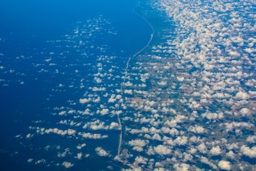Naklejka premium Beautiful cloudscape and landscape, sea shore from above, natural background