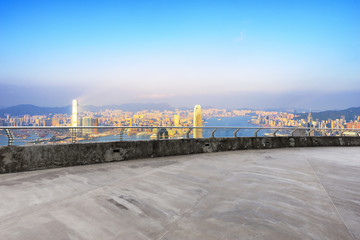 empty floor with cityscape of modern city in blue sky