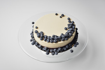cheesecake with blueberries on glass stand