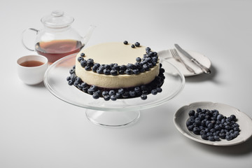 cheesecake with blueberries on glass stand