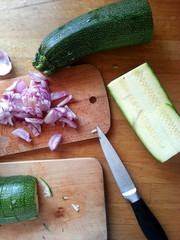 Cutting some onions and courgettes for a healthy and delicious dinner