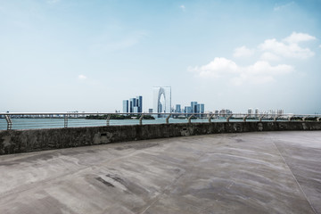 empty floor with cityscape of modern city in blue sky