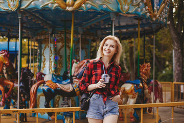 blonde girl in amusement park in summer