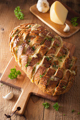 baked party bread with melted cheese butter herbs