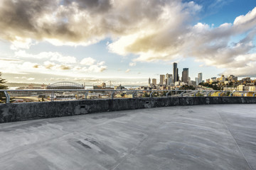 empty concrete road with cityscape of modern city in blue sky