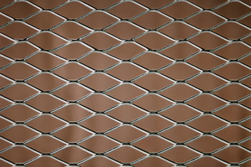 Old mesh in blurring. Colorful pattern. Steel rhombus.