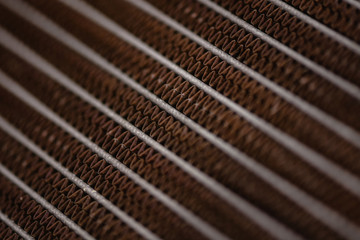 Old, rusty automotive cooler. Rusty, red lattice texture. Grid.