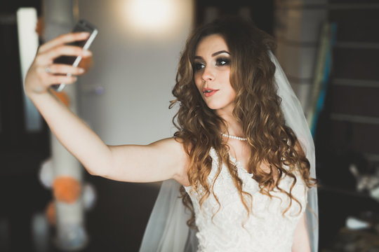 Beautiful bride making selfie in the home before wedding