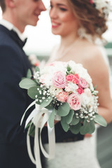 Just married wedding couple posing and bride holding in hands bouquet