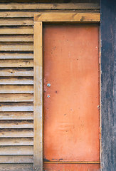 Old rusty door in a wooden house. Layout. Texture